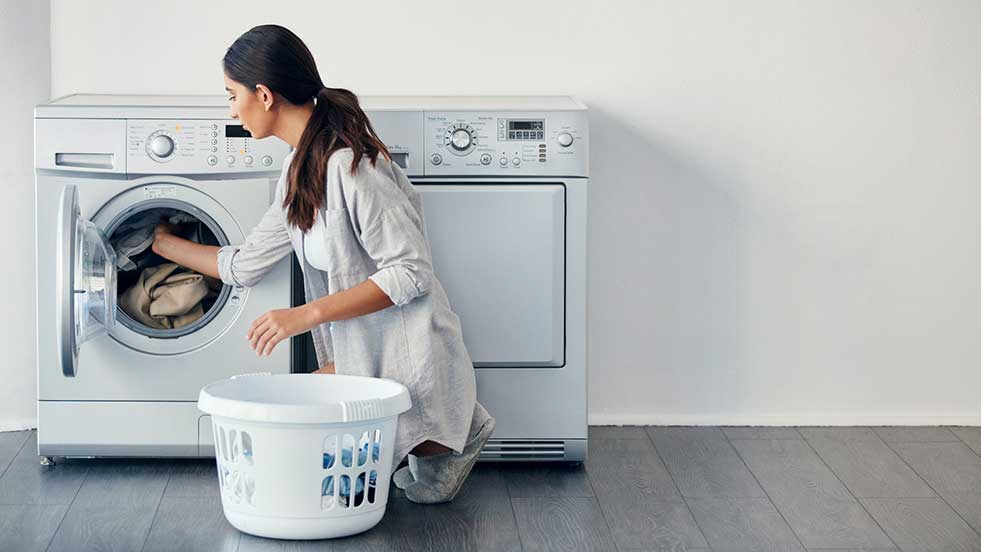 woman using washing machine