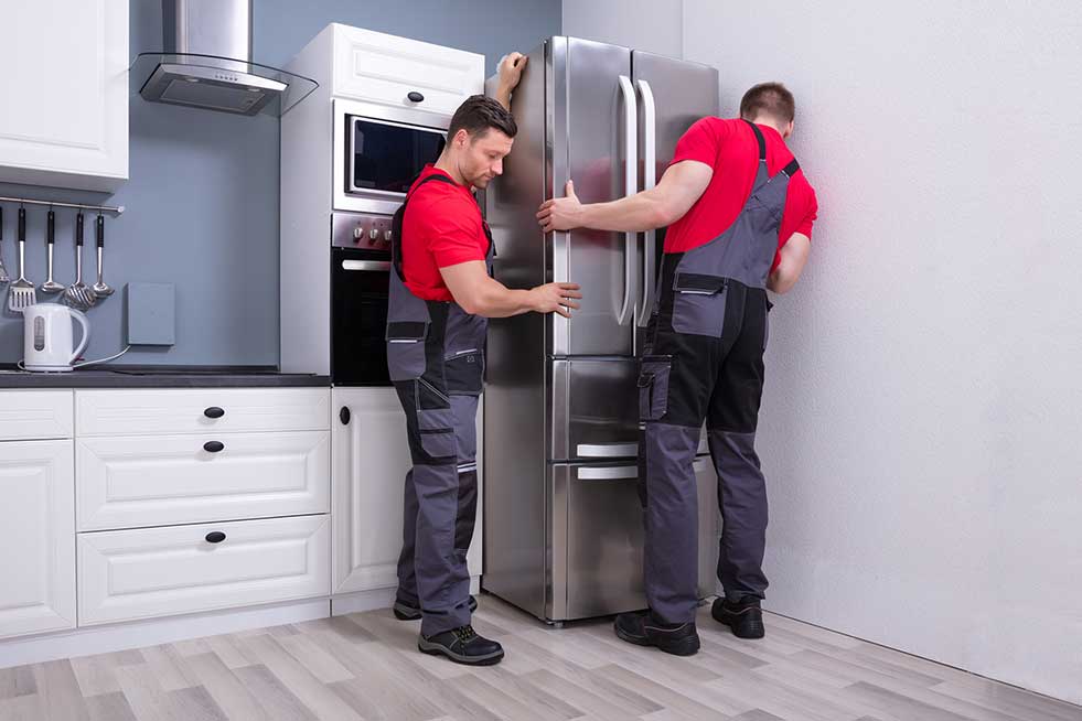 men installing a refrigerator