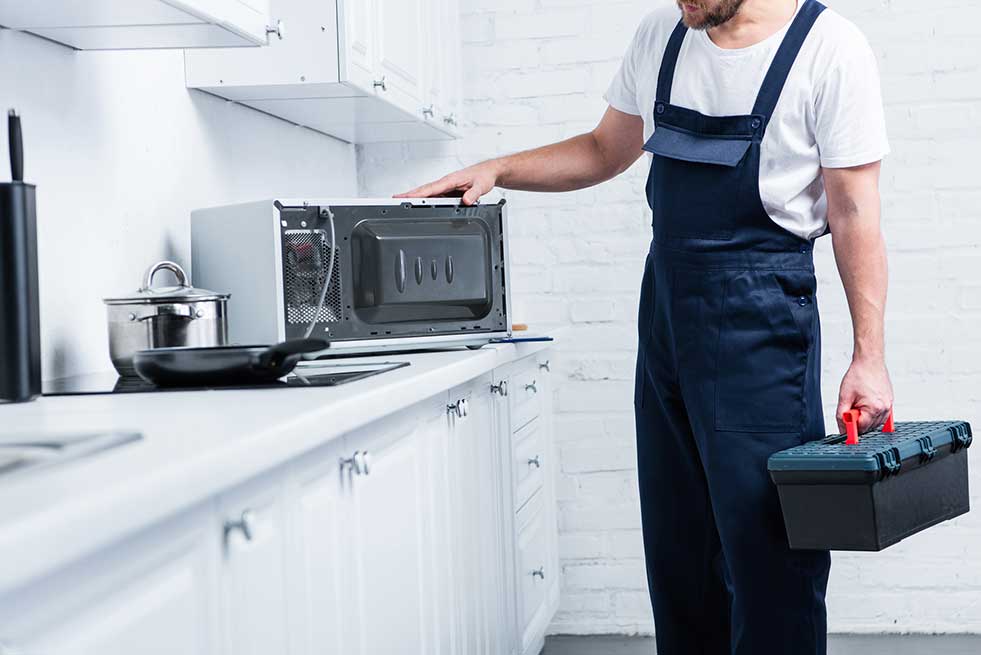 man repairing Microwave oven